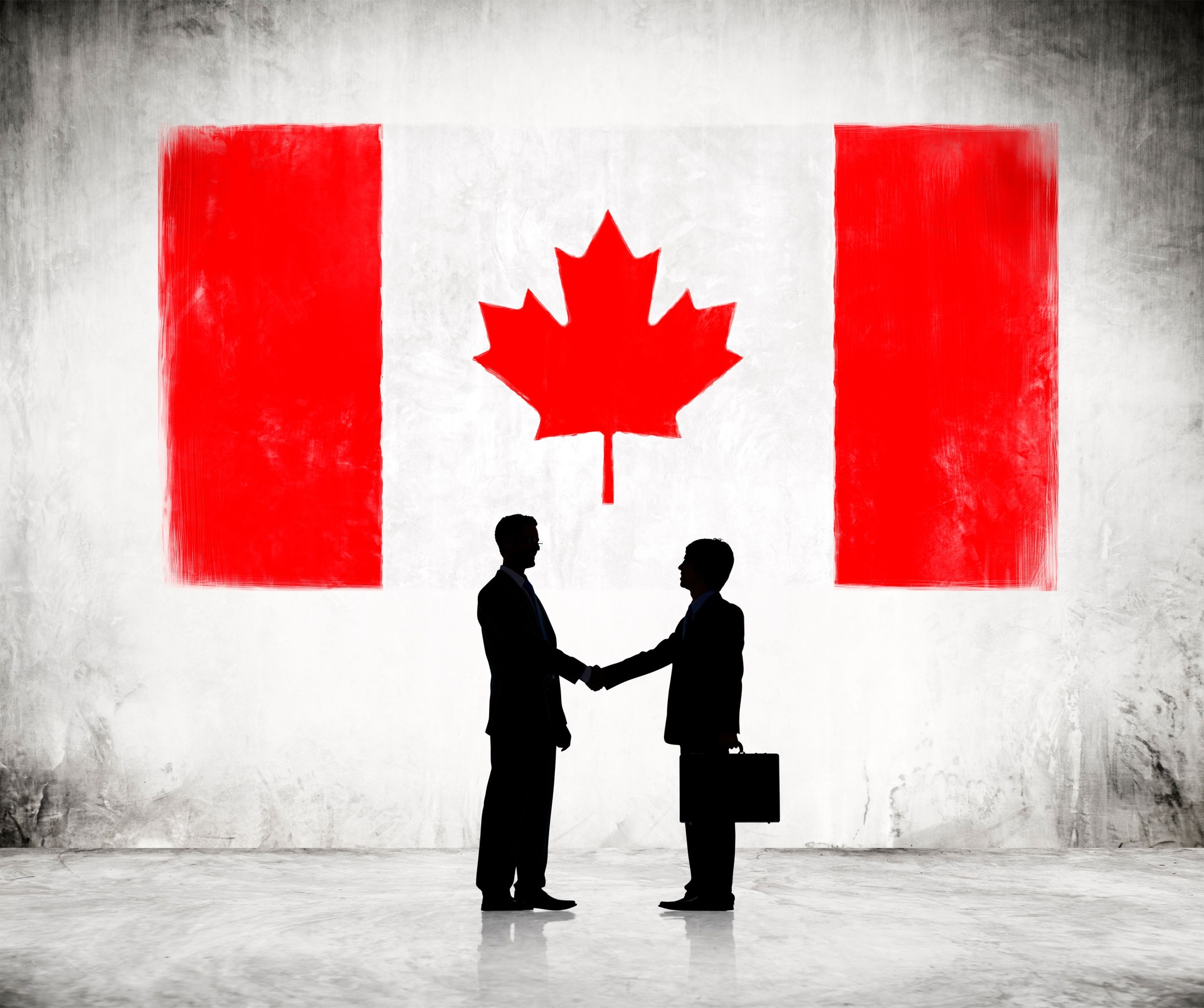 Businessmen Shaking Hands with Canadian Flag